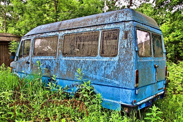 An old van covered in moss.