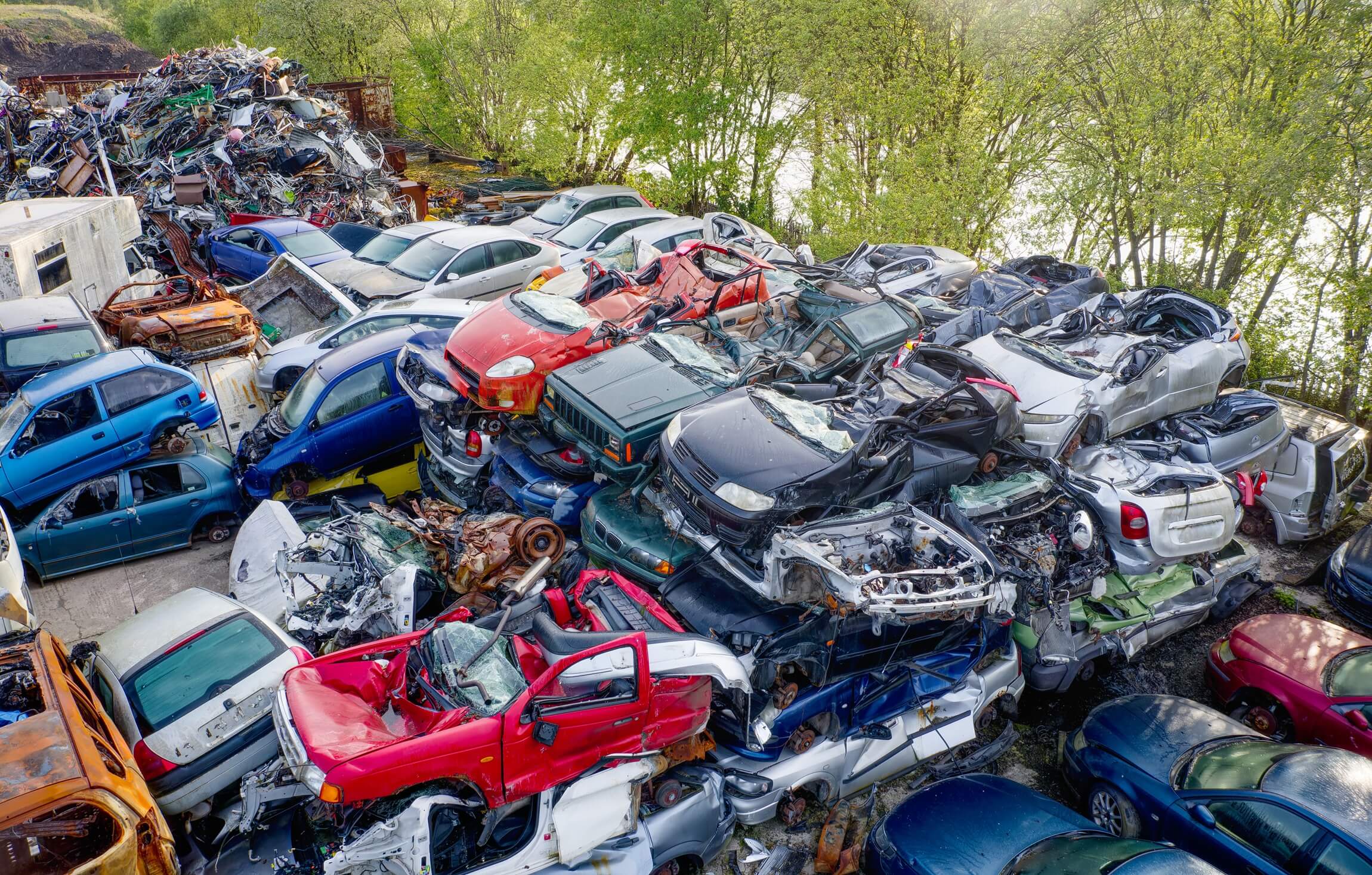 A modern, clean scrap yard with organized car parts.